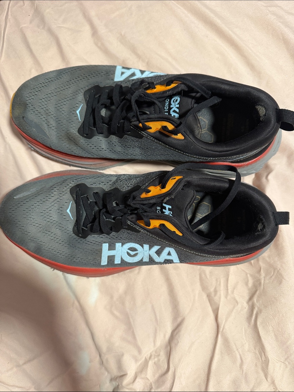 Hoka Gray Sneakers with Orange Accents and Light Blue Logo